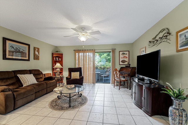 living room featuring ceiling fan, a textured ceiling, and light tile patterned floors