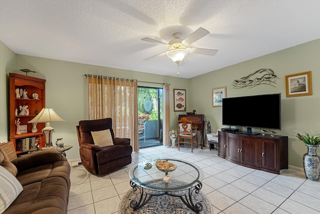 tiled living room with ceiling fan and a textured ceiling