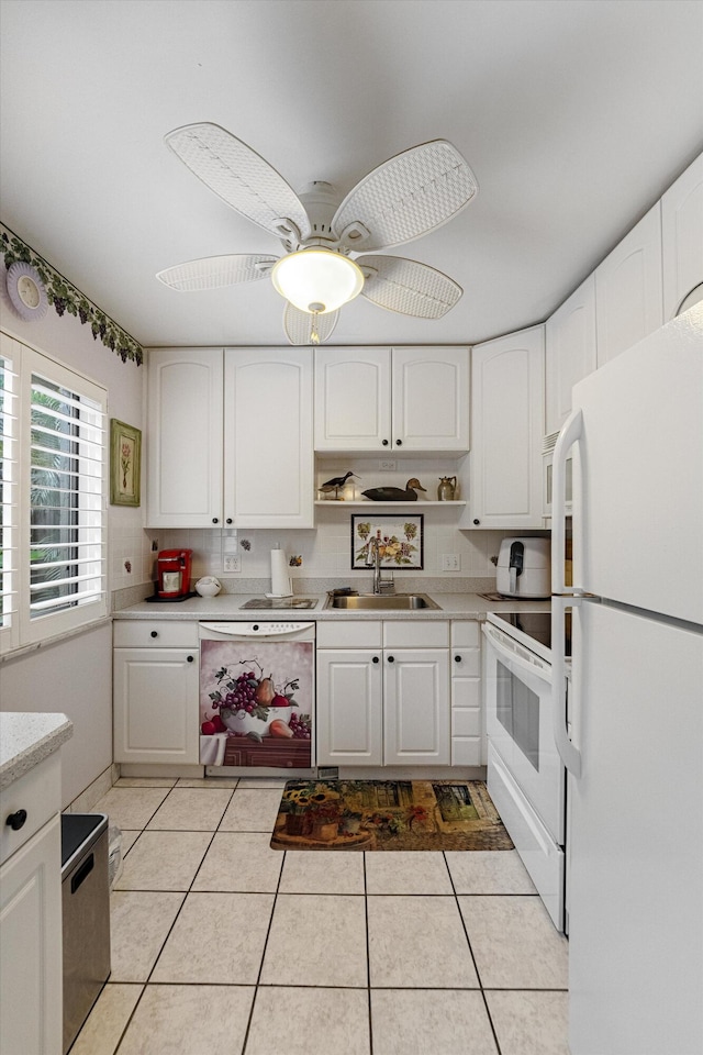 kitchen with white appliances, light tile patterned floors, white cabinetry, and sink