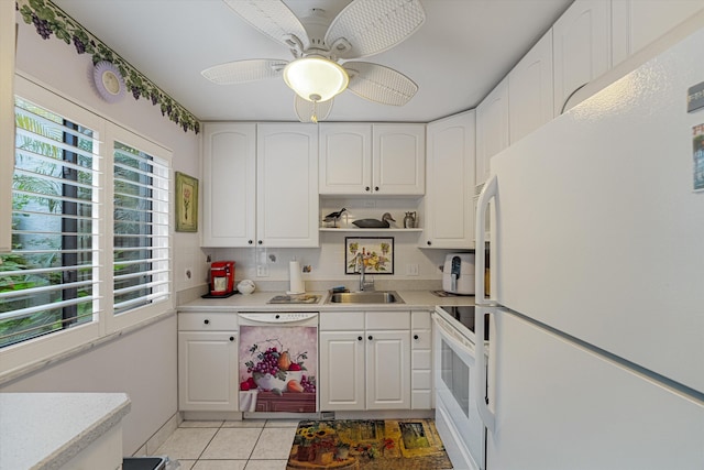 kitchen featuring sink, white cabinets, and white appliances