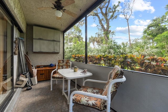 sunroom featuring ceiling fan