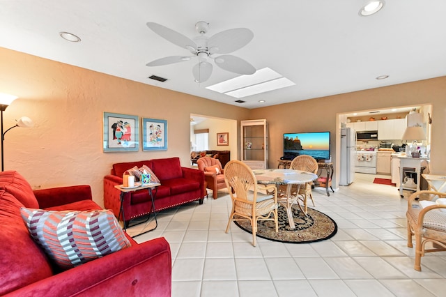 tiled living room featuring ceiling fan