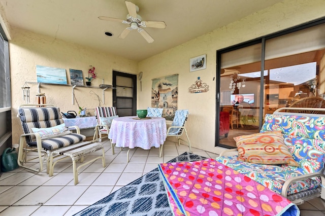 sunroom featuring ceiling fan