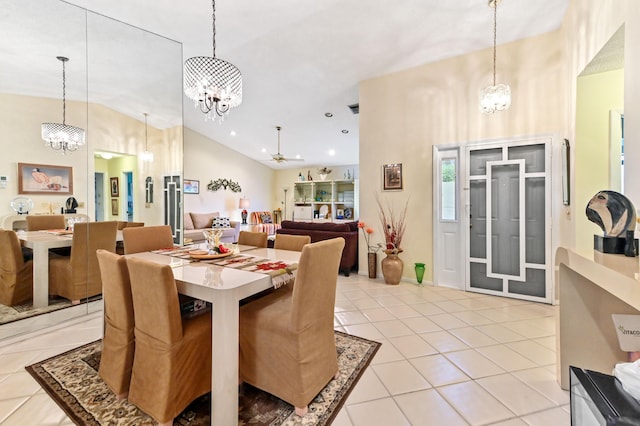 dining area with light tile patterned flooring and high vaulted ceiling