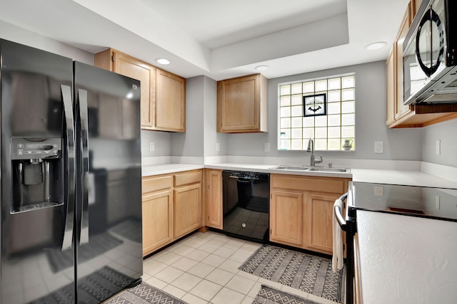 kitchen with sink, black appliances, light brown cabinets, light tile patterned floors, and a raised ceiling