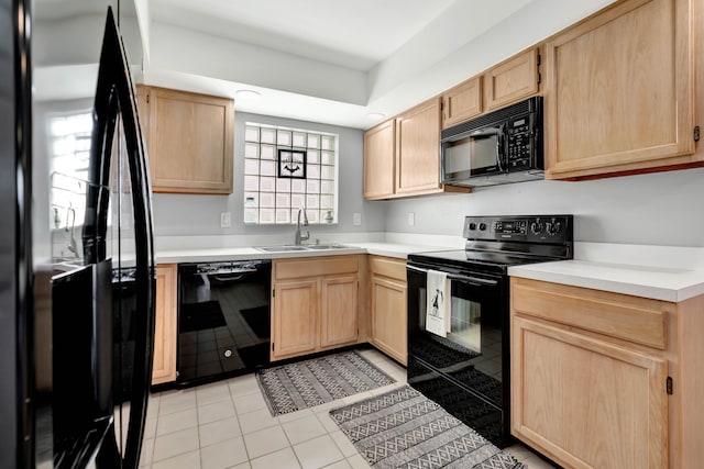 kitchen with black appliances, light brown cabinets, sink, and light tile patterned flooring