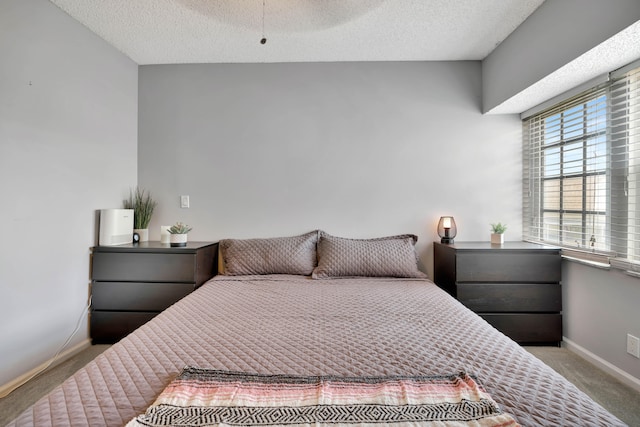 carpeted bedroom featuring a textured ceiling