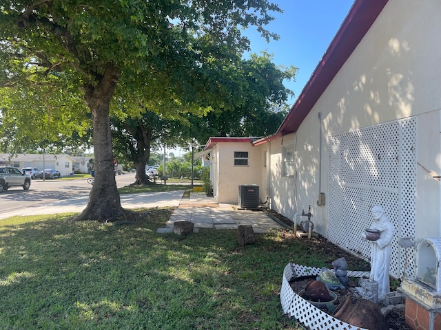 view of yard featuring a patio area and central AC unit