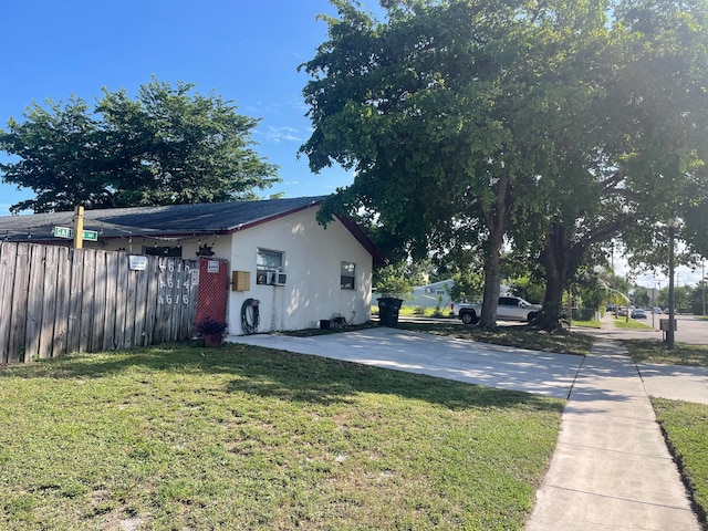 view of property exterior with a lawn