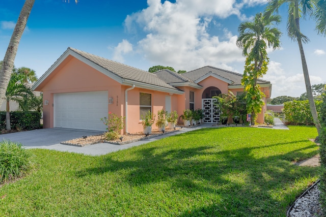 view of front of house featuring a front yard and a garage