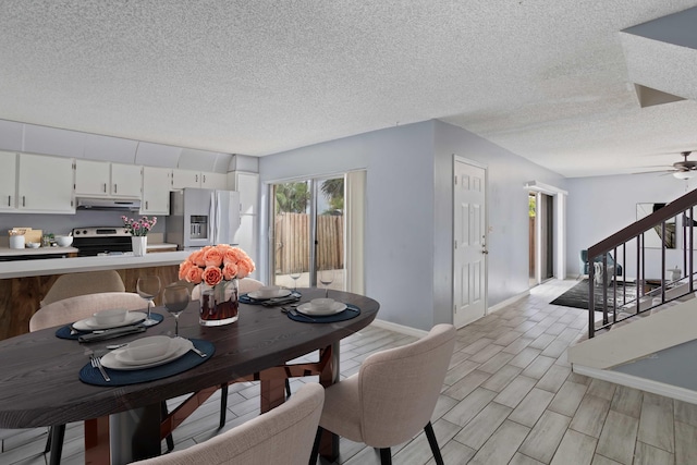 dining space featuring ceiling fan, a textured ceiling, and light wood-type flooring