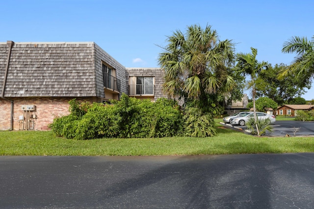 view of side of home featuring a yard