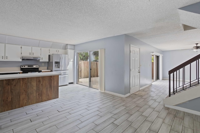 kitchen with ceiling fan, a textured ceiling, light hardwood / wood-style floors, white cabinetry, and stainless steel appliances