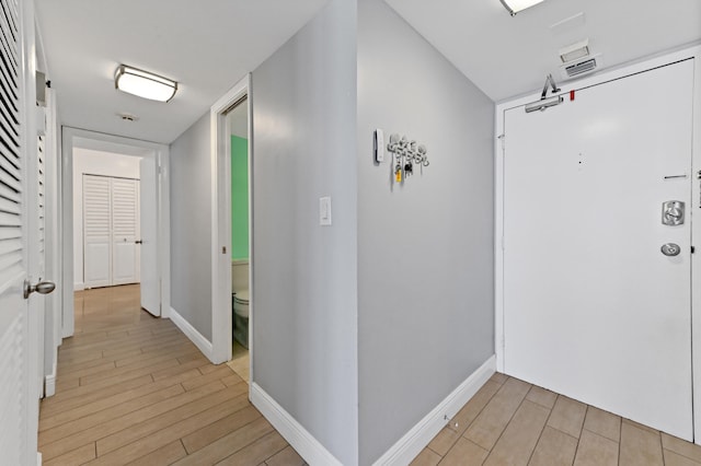 corridor with light wood-type flooring