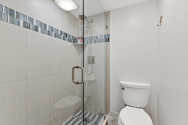 bathroom featuring toilet and walk in shower