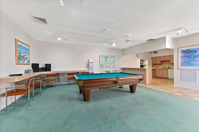 game room featuring a textured ceiling, carpet floors, and pool table