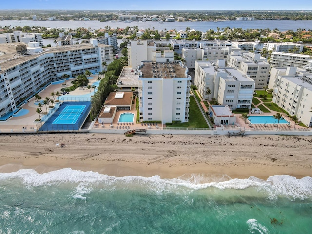 birds eye view of property featuring a water view and a beach view