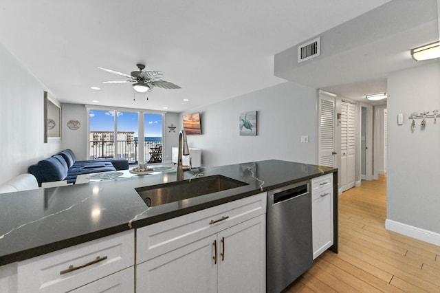 kitchen featuring sink, white cabinetry, ceiling fan, stainless steel dishwasher, and light hardwood / wood-style flooring