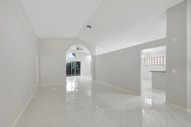 unfurnished room with light tile patterned floors, ceiling fan, and lofted ceiling