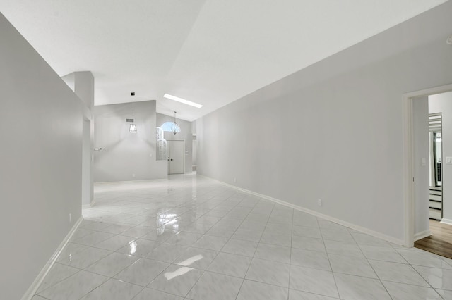 interior space with an inviting chandelier, lofted ceiling, and light tile patterned flooring