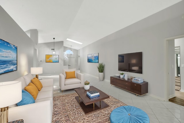 tiled living room with lofted ceiling and a chandelier