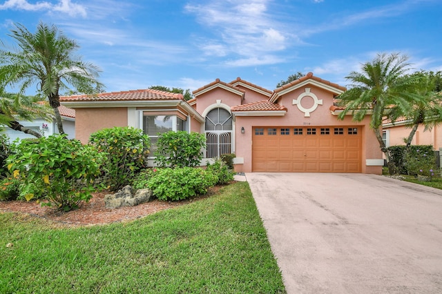 mediterranean / spanish home with a garage and a front lawn