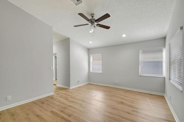 spare room with ceiling fan, a textured ceiling, and light hardwood / wood-style flooring