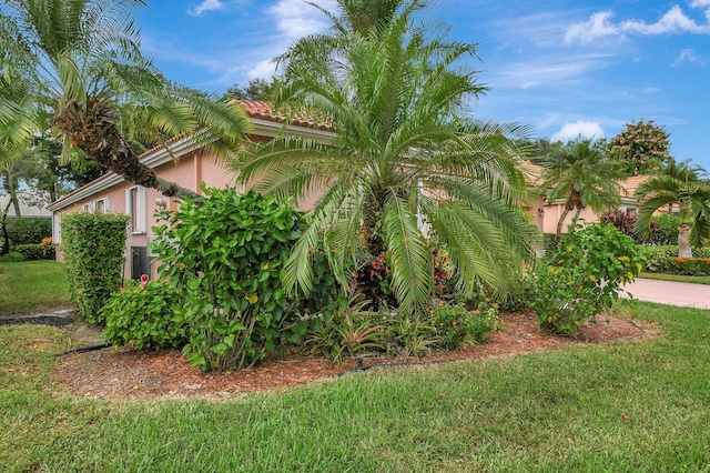 view of property exterior with a lawn