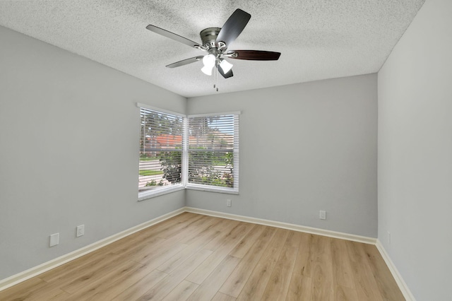 unfurnished room featuring ceiling fan, light hardwood / wood-style floors, and a textured ceiling