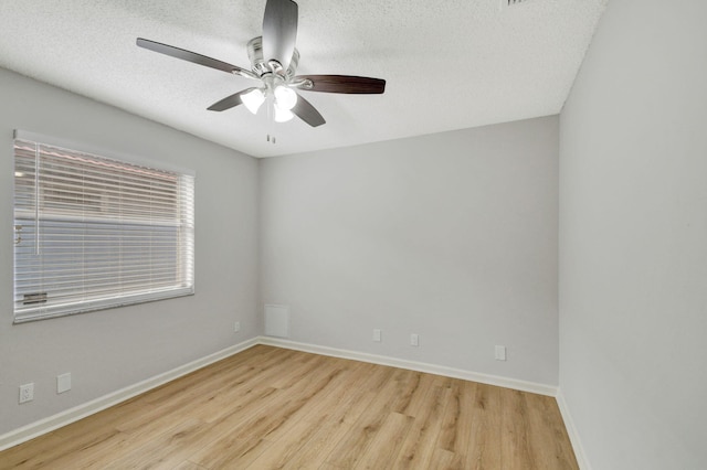 spare room with ceiling fan, a textured ceiling, and light hardwood / wood-style flooring