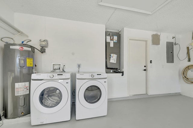 clothes washing area with washing machine and clothes dryer, a textured ceiling, electric panel, and water heater