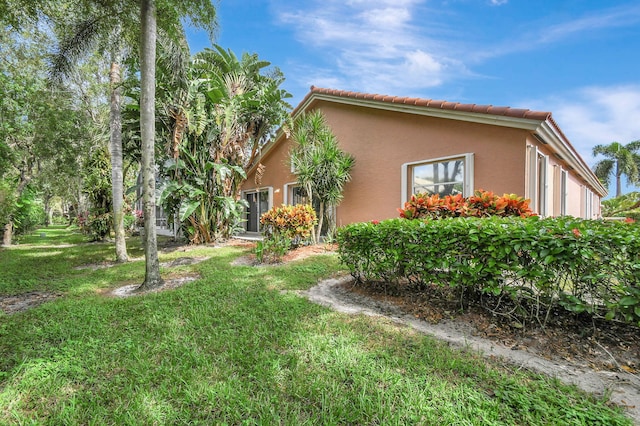 view of property exterior featuring a lawn