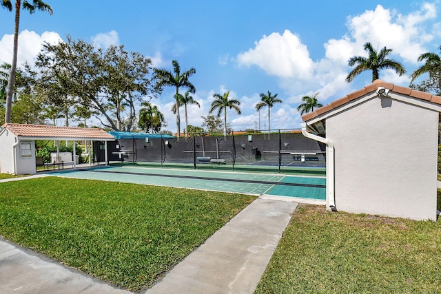 exterior space with a yard and tennis court