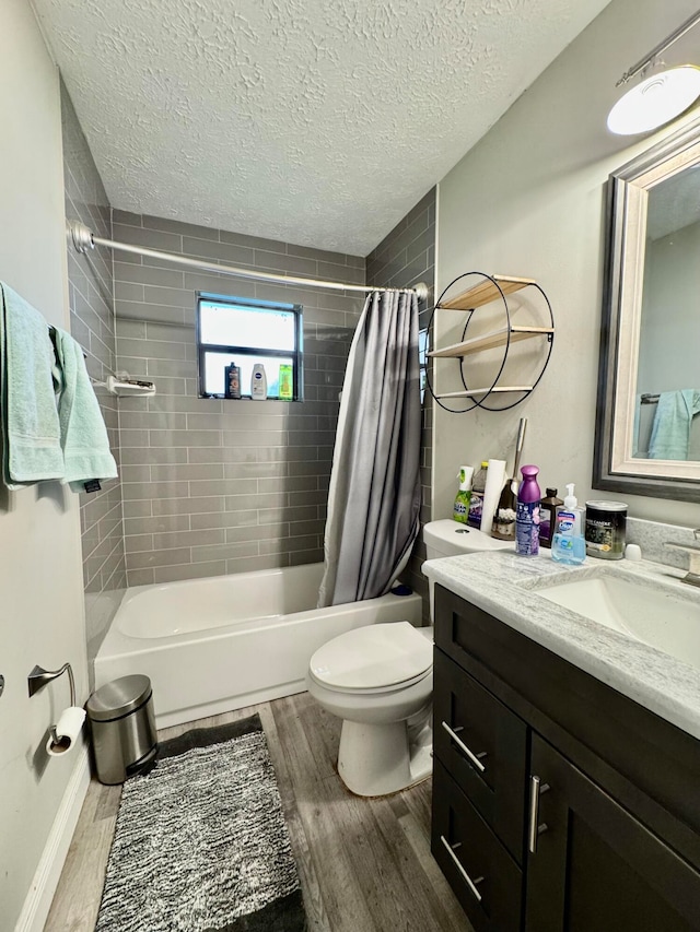 full bathroom with shower / tub combo, a textured ceiling, hardwood / wood-style flooring, toilet, and vanity