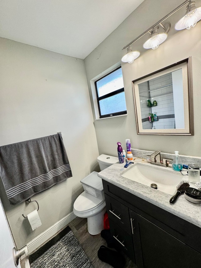 bathroom with vanity, hardwood / wood-style flooring, and toilet