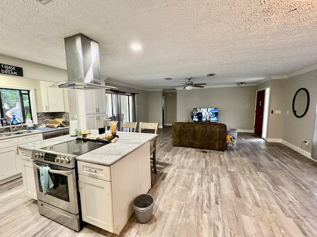 kitchen with light hardwood / wood-style flooring, white cabinets, stainless steel range with electric cooktop, and island range hood