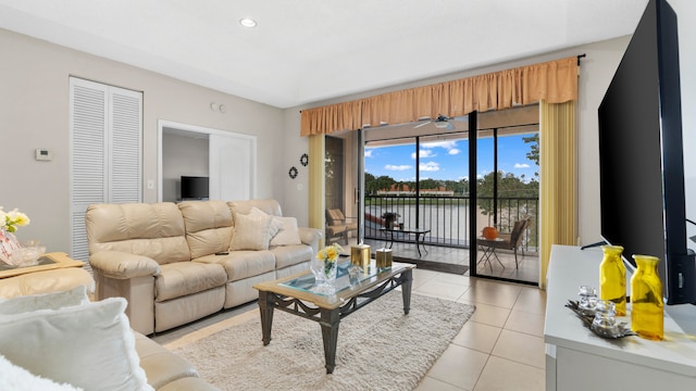 tiled living room with ceiling fan