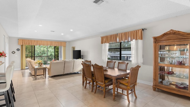 tiled dining room with a textured ceiling