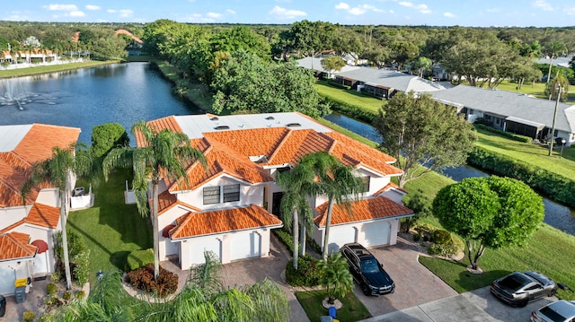 birds eye view of property with a water view