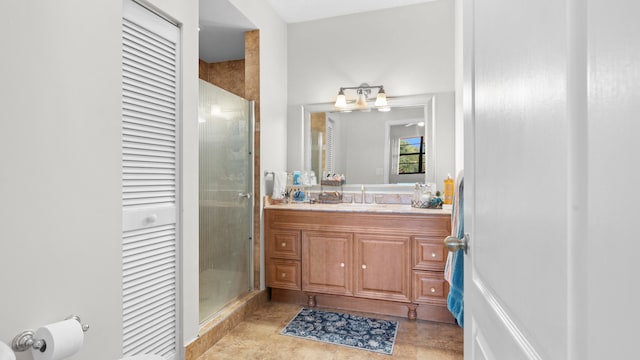 bathroom with vanity and a shower with door