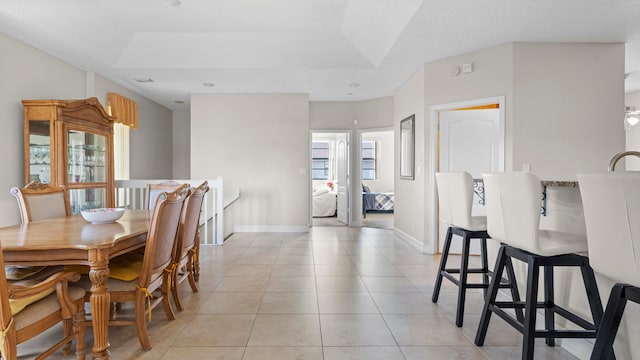 dining space featuring light tile patterned floors