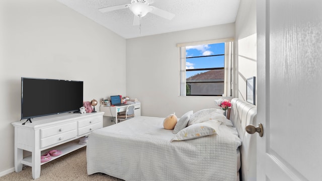 carpeted bedroom with a textured ceiling and ceiling fan