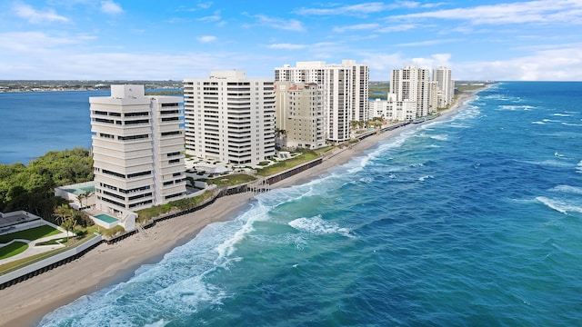 birds eye view of property featuring a water view and a beach view