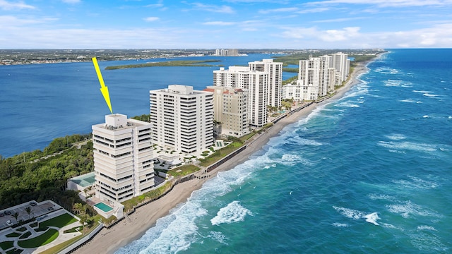 drone / aerial view with a water view and a beach view