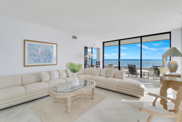 living room with a water view and a wall of windows