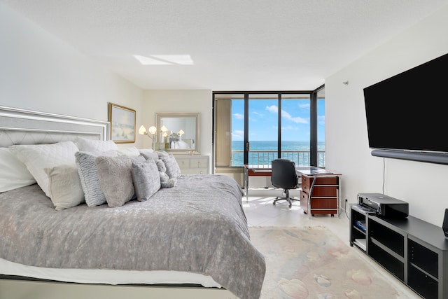 bedroom with a textured ceiling and floor to ceiling windows