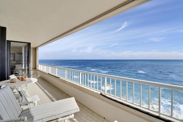 balcony with a water view and a beach view