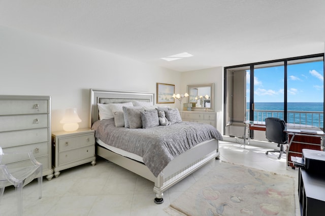 tiled bedroom featuring a water view