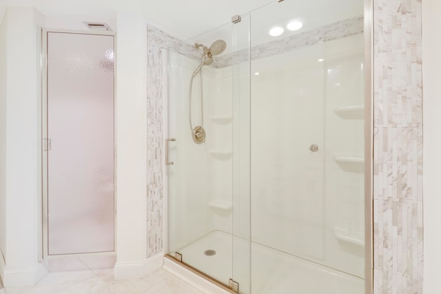 bathroom featuring tile patterned flooring and a shower with door