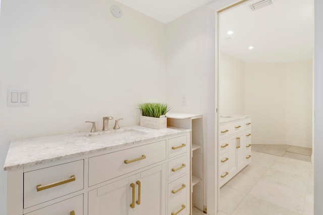 bathroom featuring tile patterned flooring and vanity